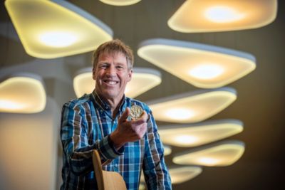 Mark Johnson holding prototype component in Philips lighting innovation space