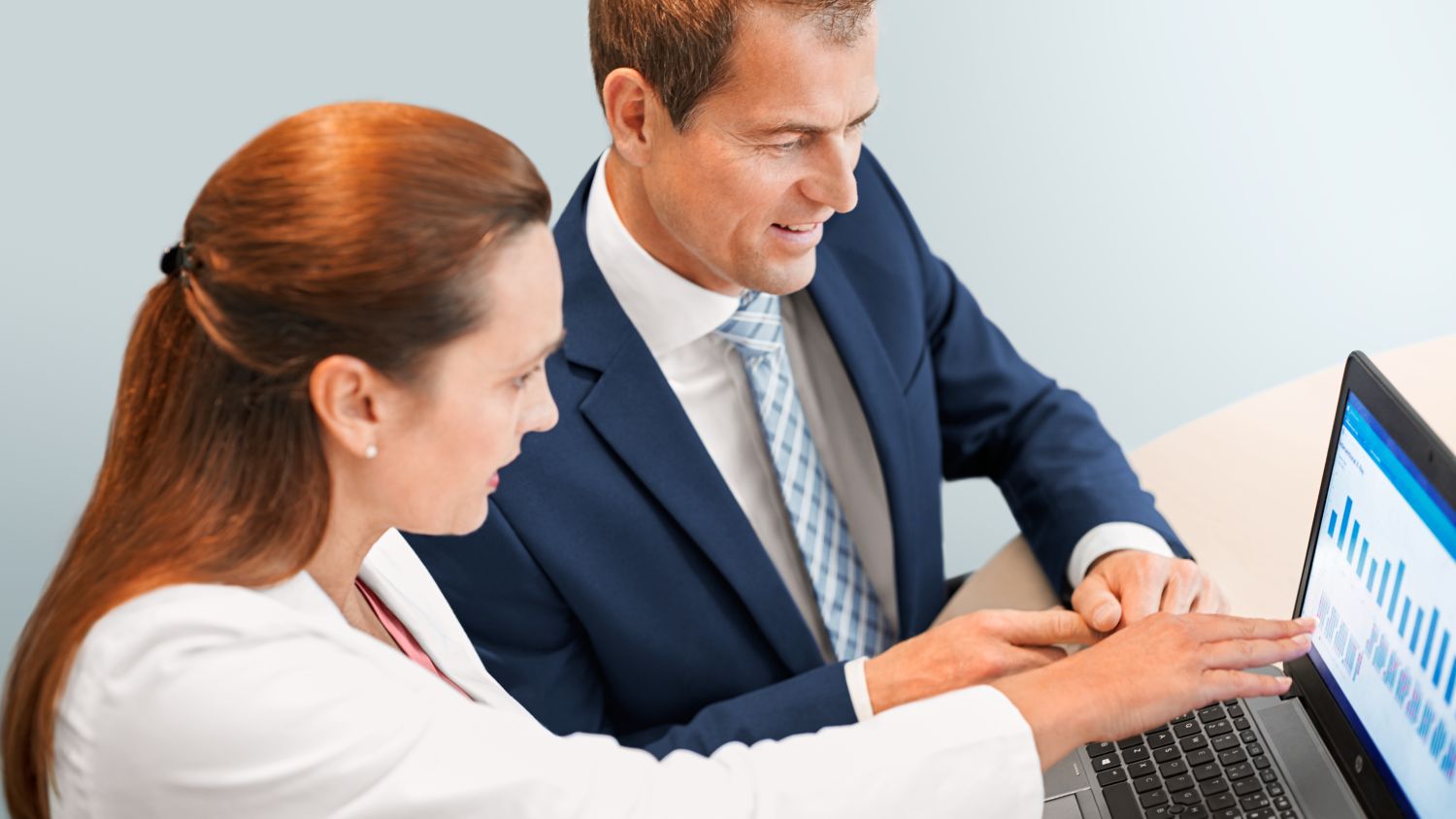 Executives look at data on computer