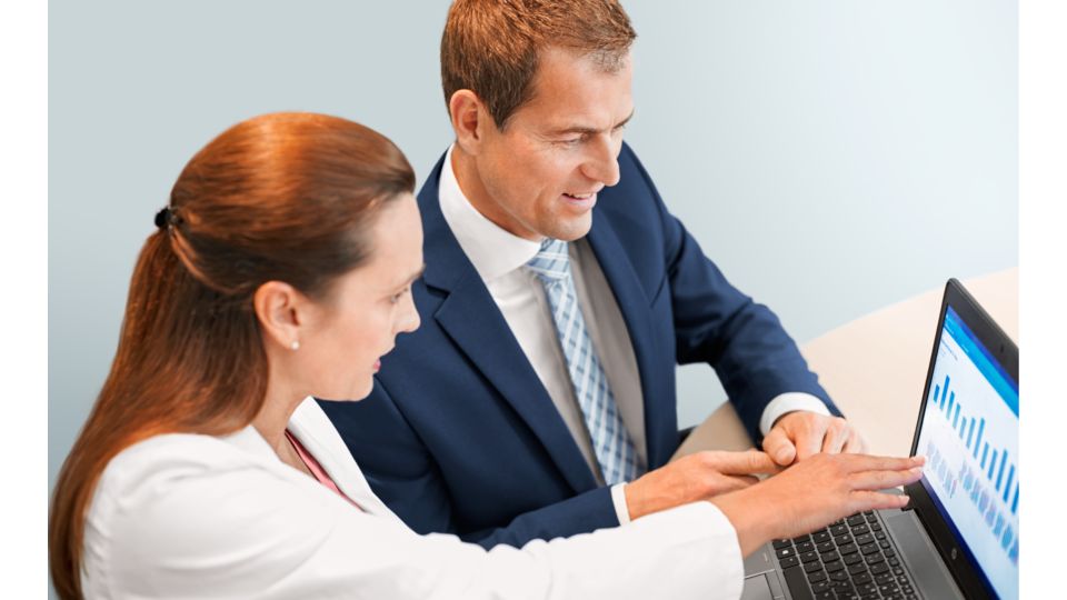 Executives look at data on computer