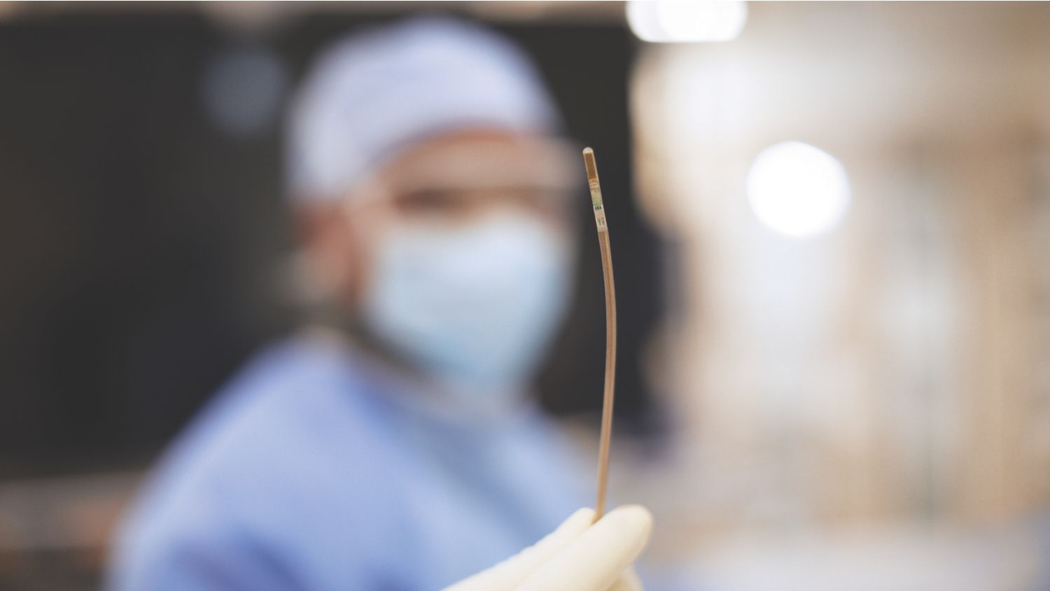 A physician in the background holding a VeriSight Pro catheter in the foreground