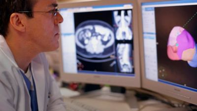 Doctor reviewing radiology images on screen