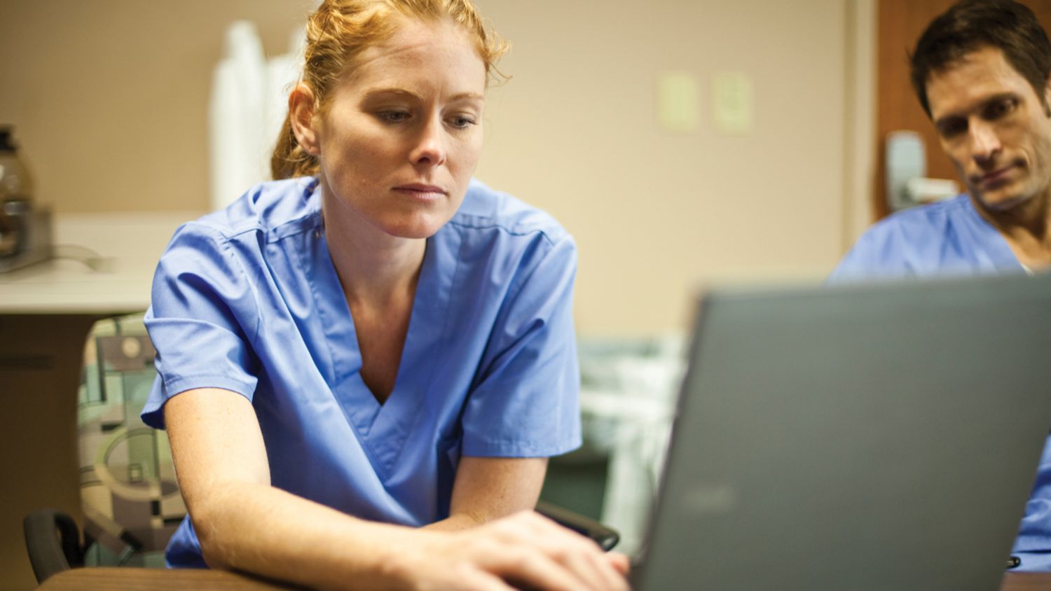 Clinician reviewing screens.