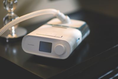 Philips DreamStation CPAP device on bedside table