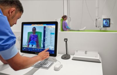 Clinician uses Philips pediatric imaging console to position a child patient for X-ray examination