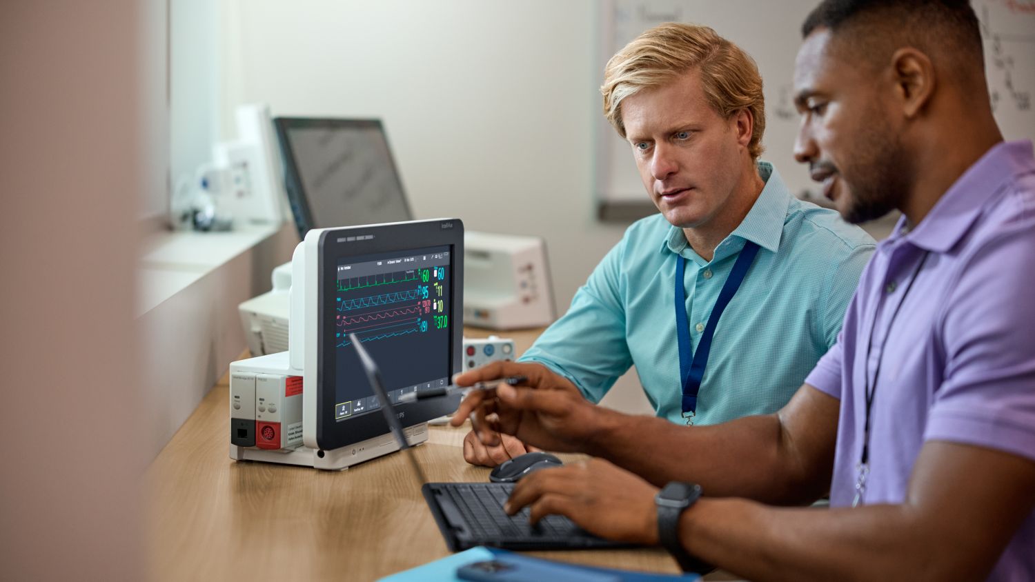 Hospital executive in a server room discussing cybersecurity with hospital IT leader