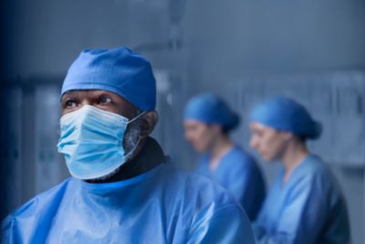 Medical professionals in blue surgical gowns