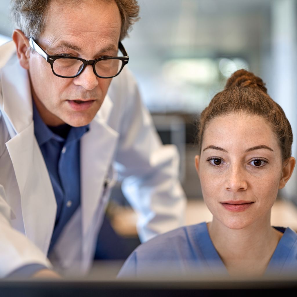 Doctors looking at oncology and pathology workflows