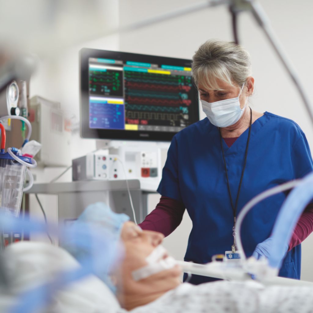 Nurse with male patient in ICU CCU