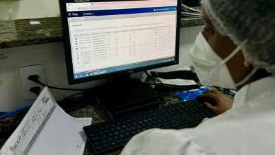 Healthcare staff using Philips Tasy system on computer in clinical workspace