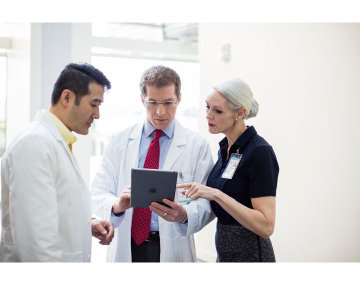 A group of people looking at a tablet