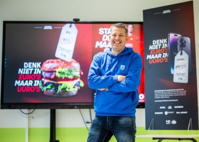 Mens die zich voor promotionele vertoning over euro en smartphones bevinden