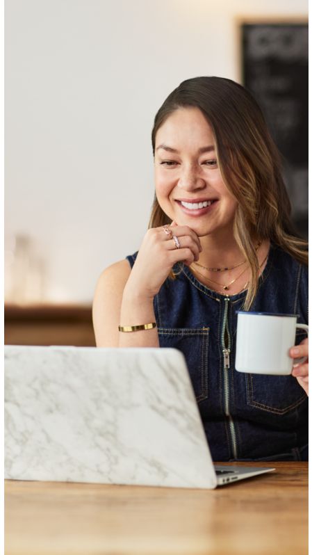 Woman using a laptop and smiling